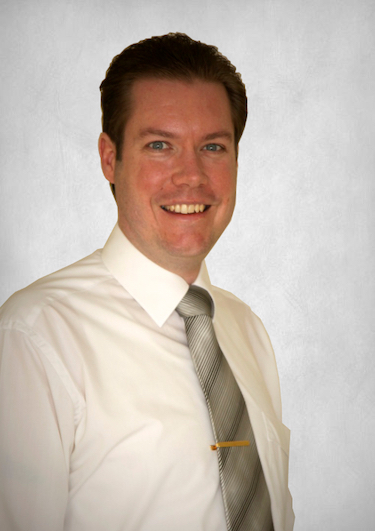 A portrait of Travis Nice on a Grey Slate Background